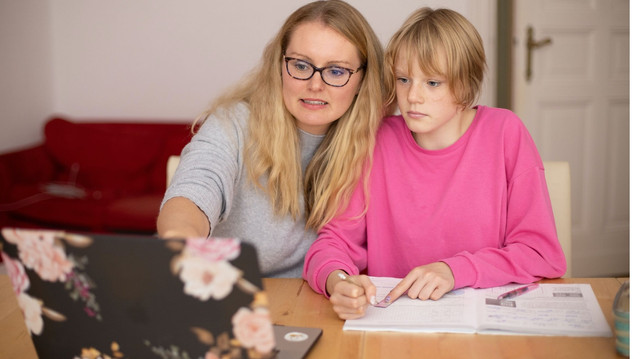 Parent helping student doing homework.